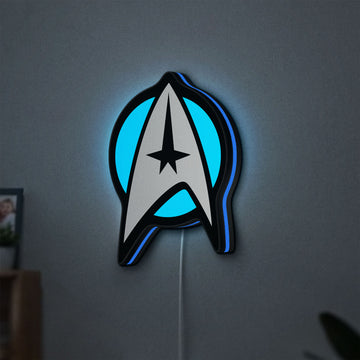 Star Trek Emblem LED lightbox hanging on a wall with blue glow