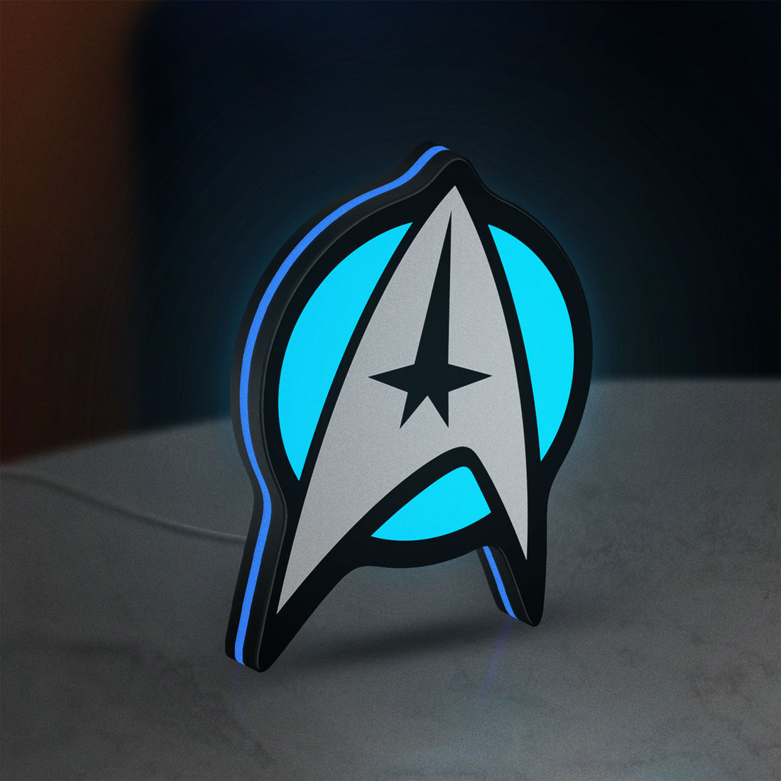 Star Trek Emblem LED lightbox hanging on a wall with blue glow