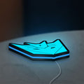 Decepticons LED lightbox lying flat on a desk with blue glow