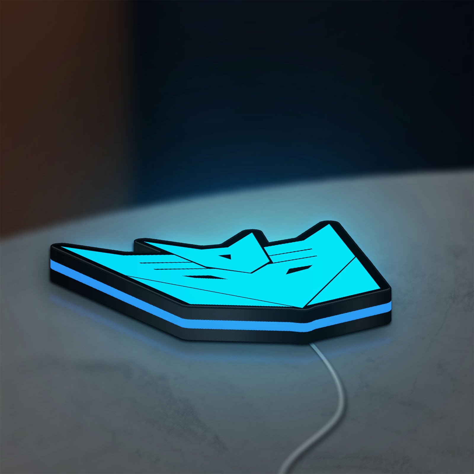 Decepticons LED lightbox lying flat on a desk with blue glow