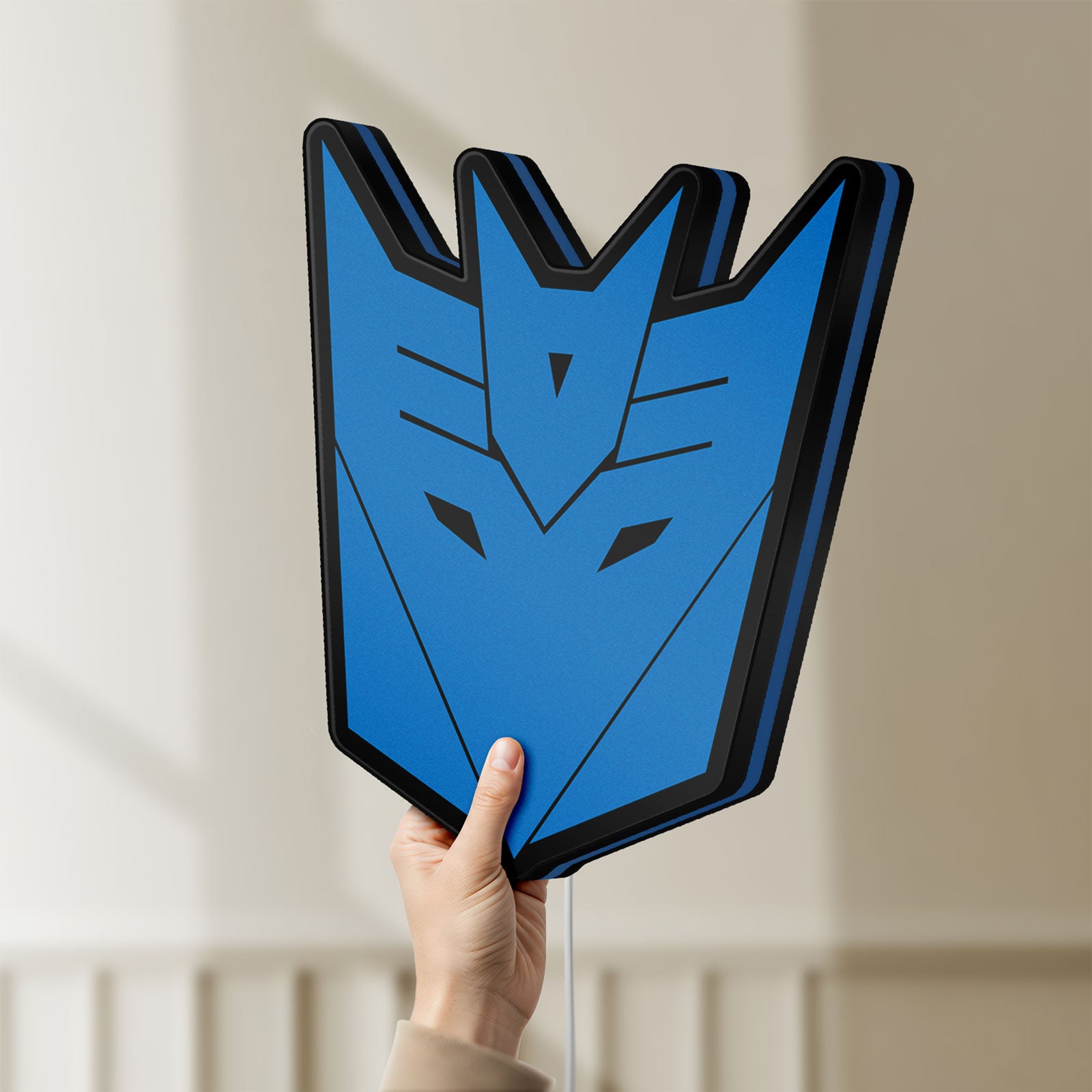 Unlit Decepticons LED lightbox held by hand to show size and details