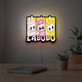 Labubu LED lightbox hanging on a room wall with soft yellow light