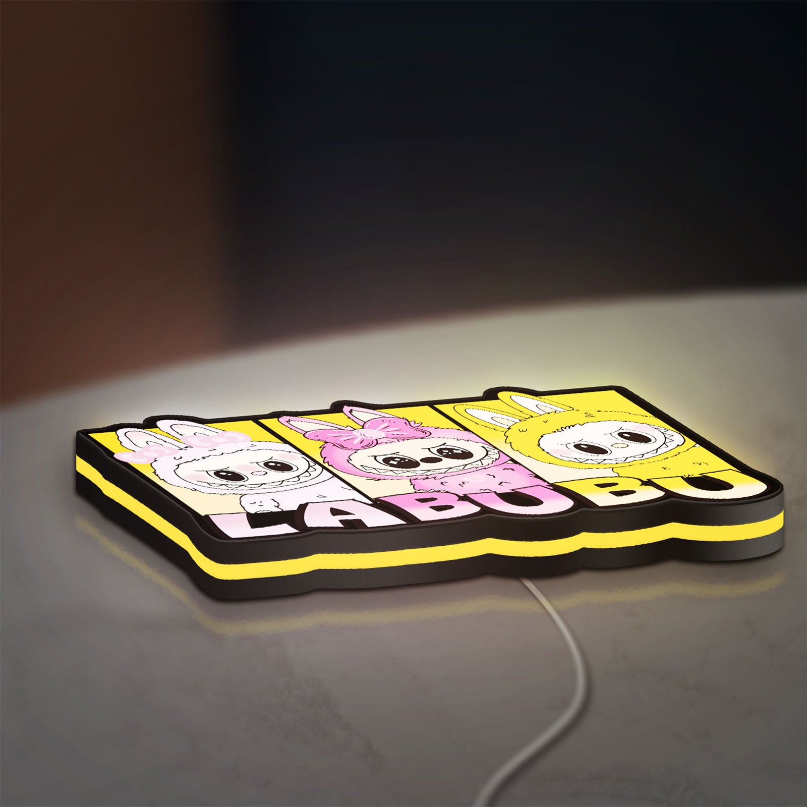 Labubu LED lightbox lying flat on a desk with yellow glow