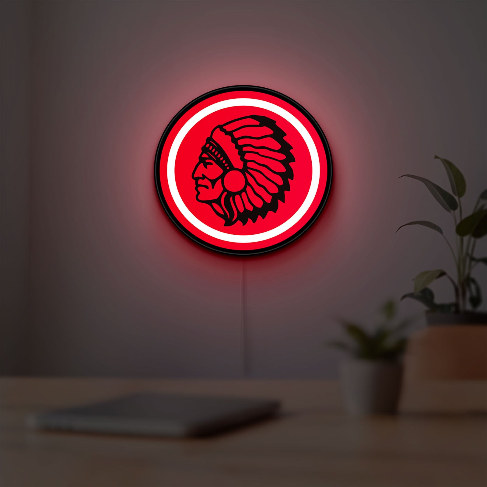 Apache Indian LED lightbox hanging on a room wall with soft red light