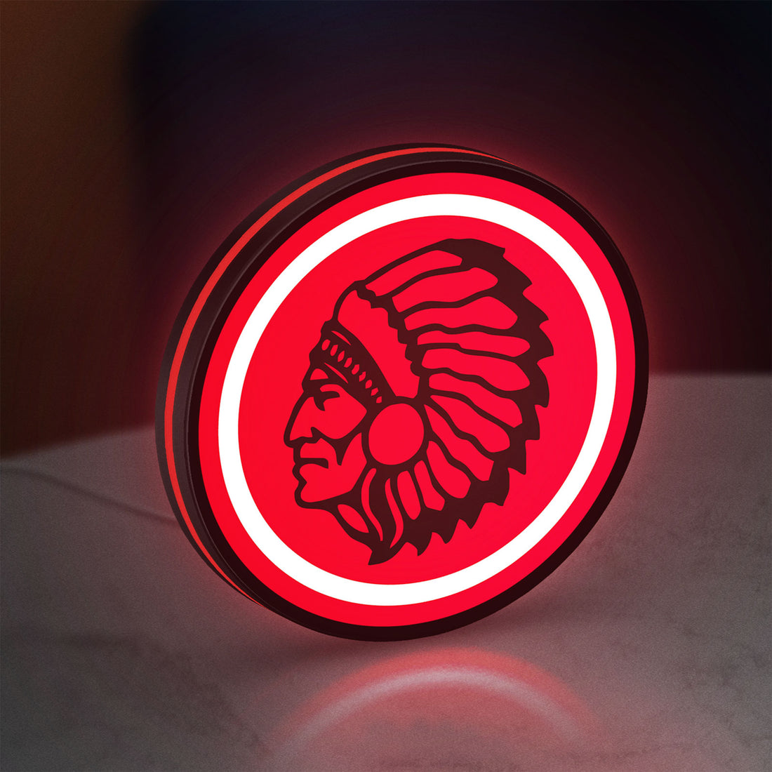Apache Indian LED lightbox hanging on a wall with red glow