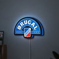 Brugal LED lightbox hanging on a wall with blue glow