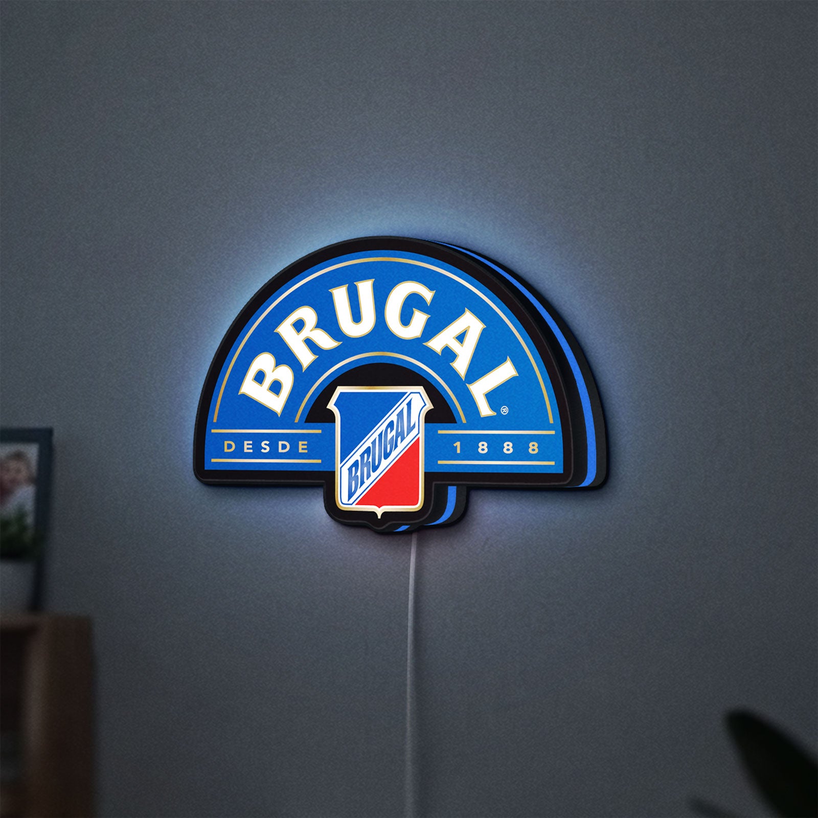 Brugal LED lightbox hanging on a wall with blue glow