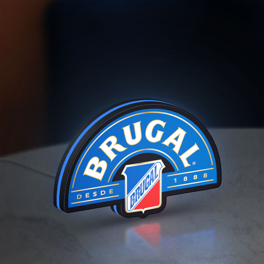 Brugal LED lightbox hanging on a wall with blue glow