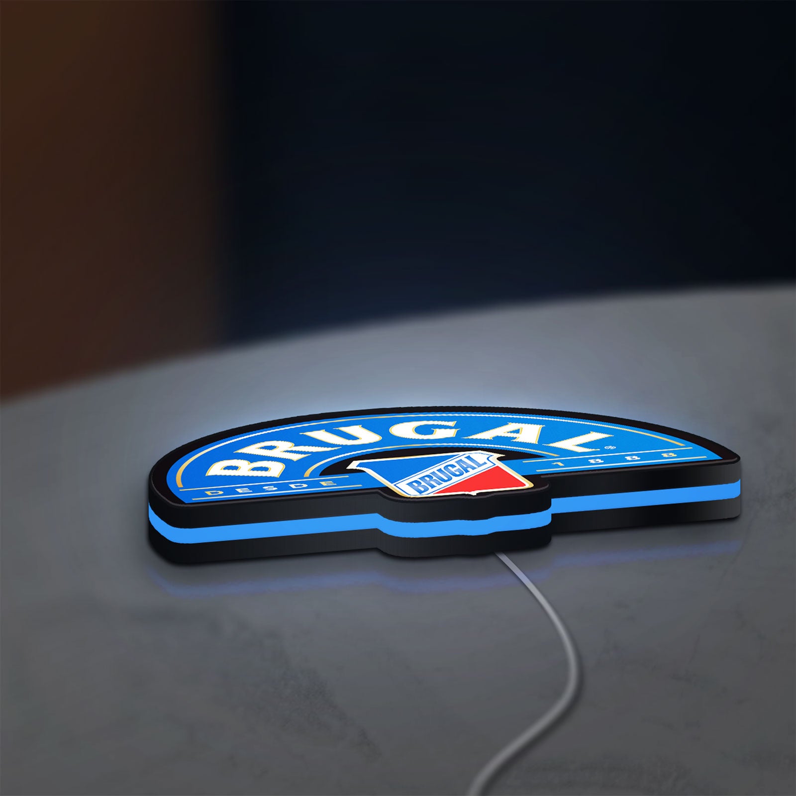 Brugal LED lightbox lying flat on a desk with blue glow