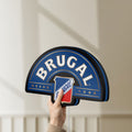 Unlit Brugal LED lightbox held by hand to show size and details