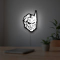 Joker LED lightbox hanging on a room wall with soft white light