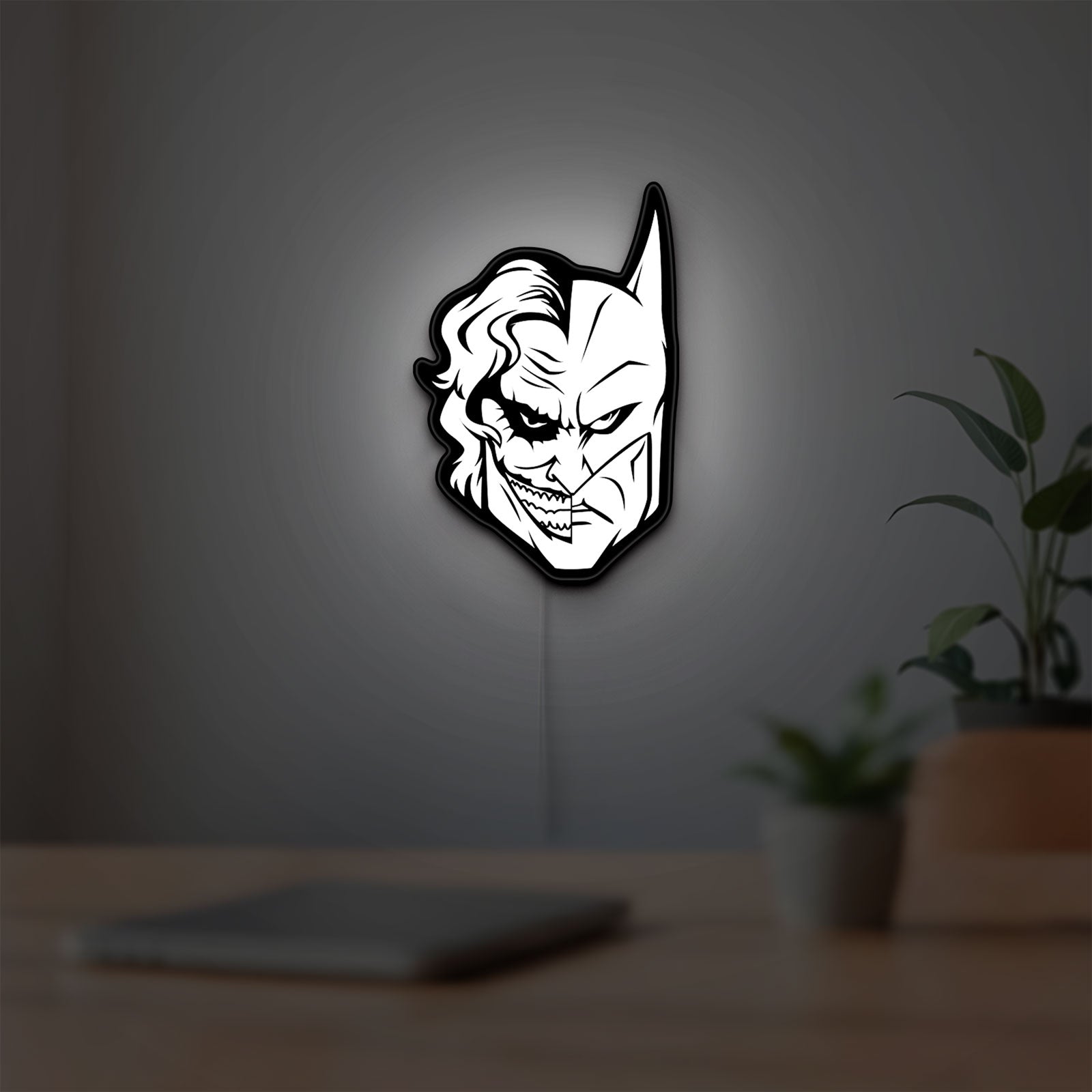 Joker LED lightbox hanging on a room wall with soft white light