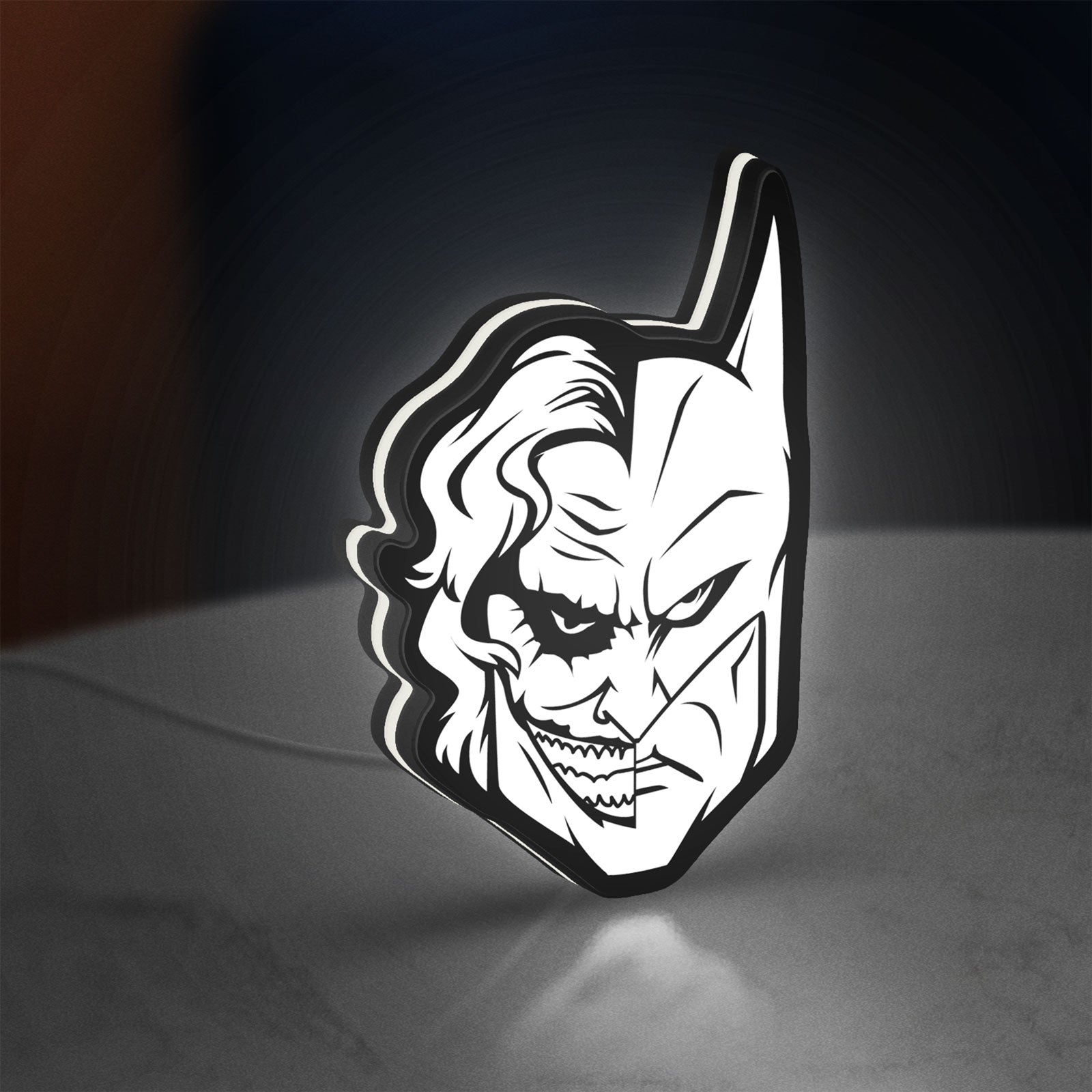 Joker LED lightbox standing on a desk from an angled side view with white glow