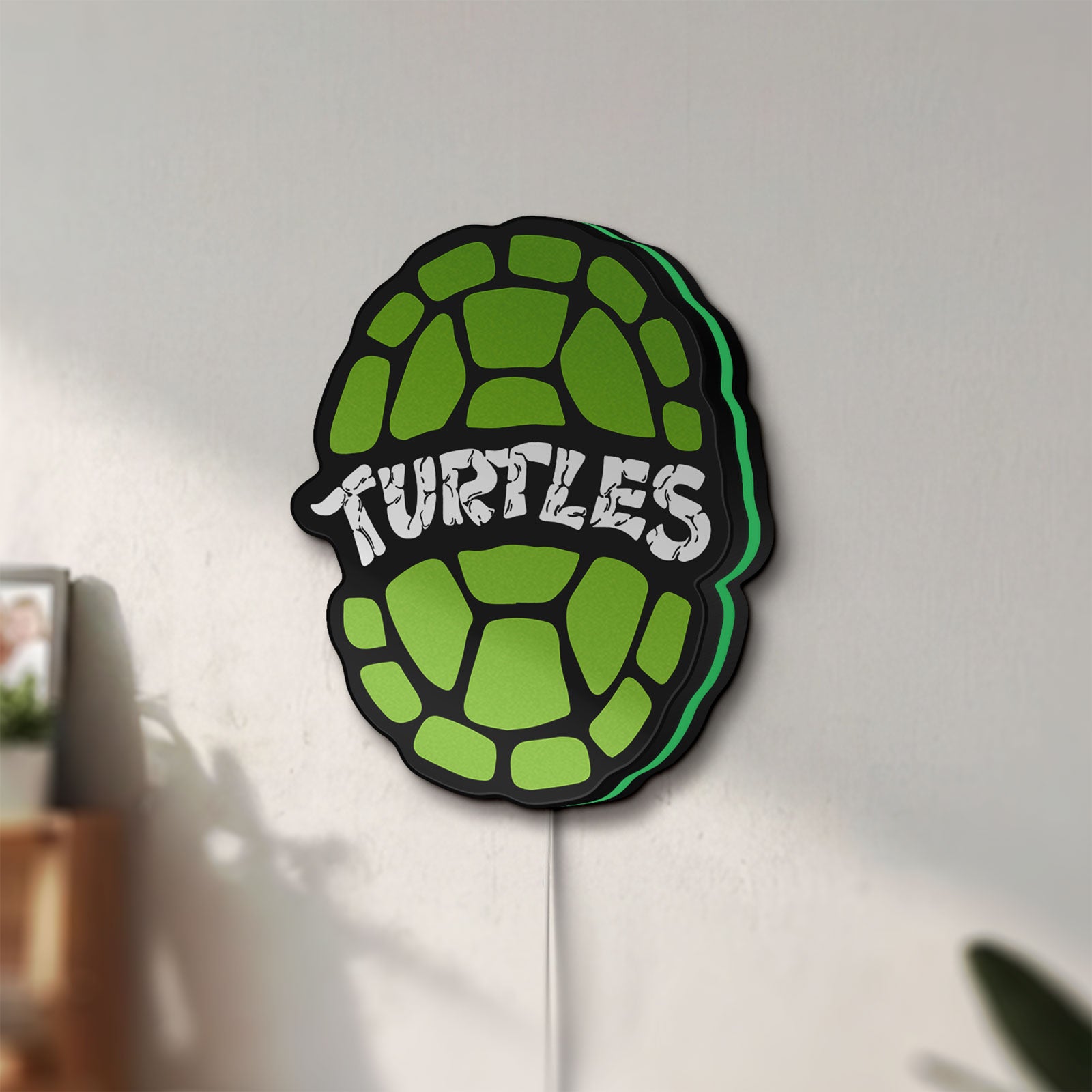 Unlit Teenage Mutant Ninja Turtles LED lightbox mounted on a wall in daylight