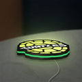 Teenage Mutant Ninja Turtles LED lightbox lying flat on a desk with green glow