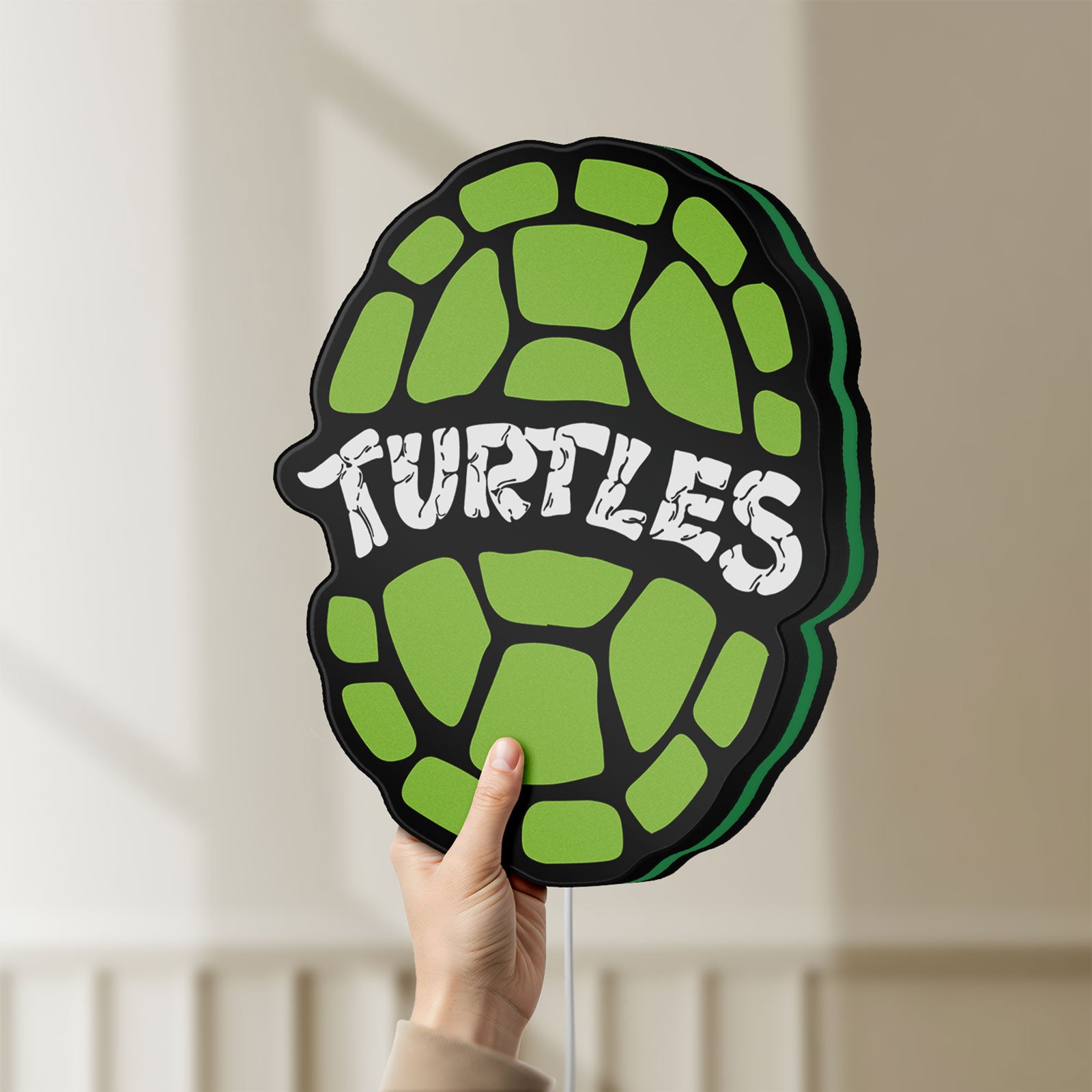 Unlit Teenage Mutant Ninja Turtles LED lightbox held by hand to show size and details