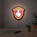 Mickey Mouse LED lightbox hanging on a room wall with soft yellow light
