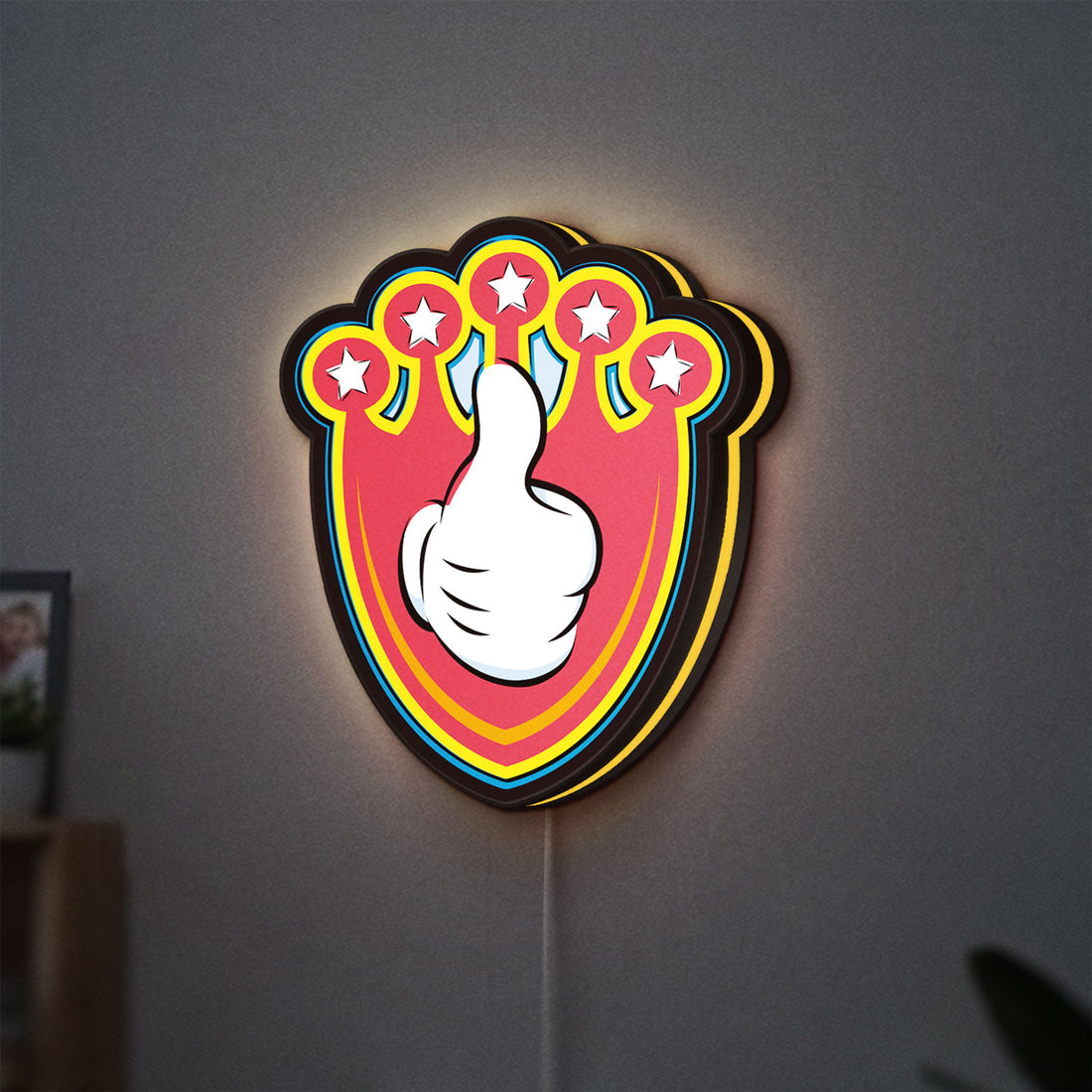 Mickey Mouse LED lightbox hanging on a wall with yellow glow