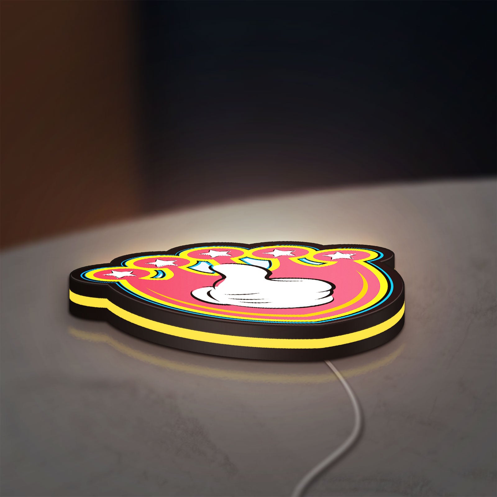 Mickey Mouse LED lightbox lying flat on a desk with yellow glow