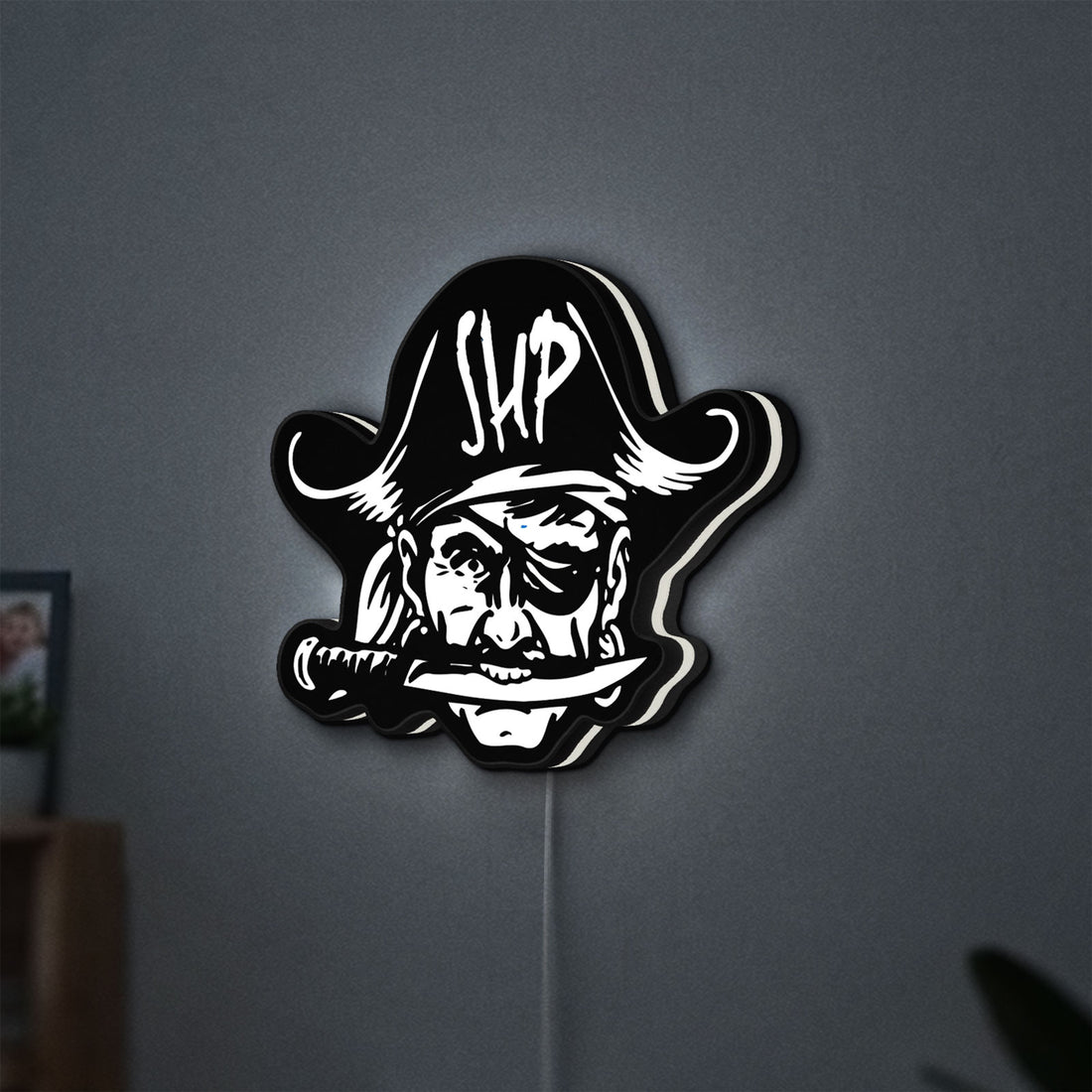 Straw Hat Pirates LED lightbox hanging on a wall with white glow