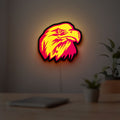 Eagle Head LED lightbox hanging on a room wall with soft yellow light