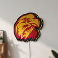 Unlit Eagle Head LED lightbox mounted on a wall in daylight