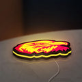 Eagle Head LED lightbox lying flat on a desk with yellow glow