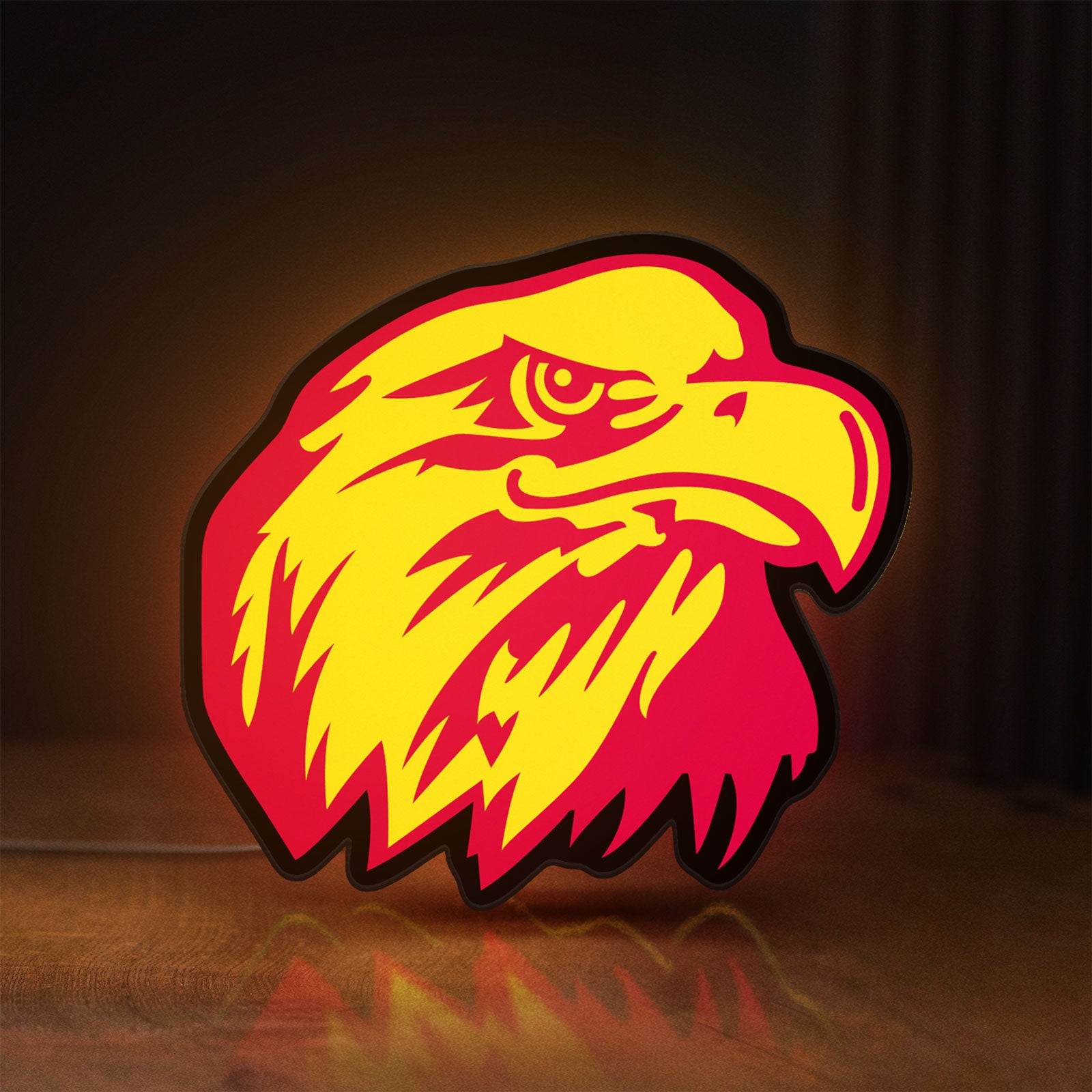 Front view of Eagle Head LED lightbox sign glowing on a wooden desk