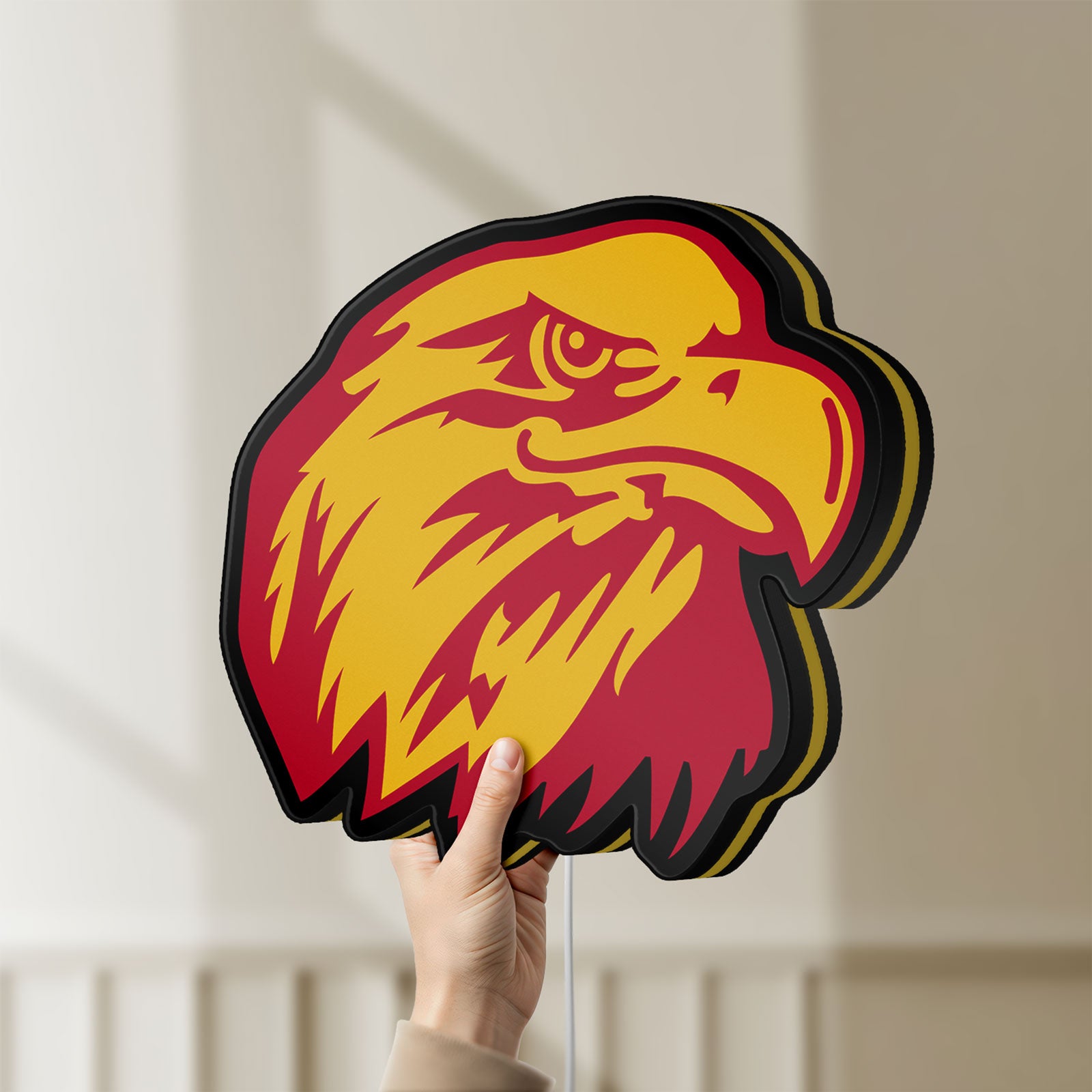 Unlit Eagle Head LED lightbox held by hand to show size and details