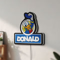 Unlit Donald LED lightbox mounted on a wall in daylight