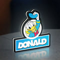 Donald LED lightbox standing on a desk from an angled side view with white glow