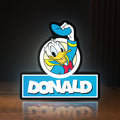 Front view of Donald LED lightbox sign glowing on a wooden desk
