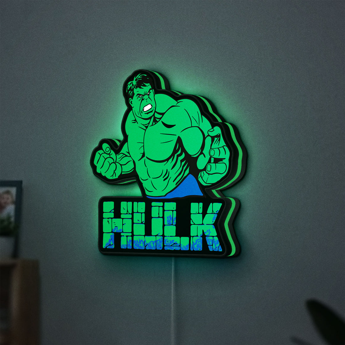 Hulk LED lightbox hanging on a wall with green glow