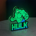 Hulk LED lightbox standing on a desk from an angled side view with green glow