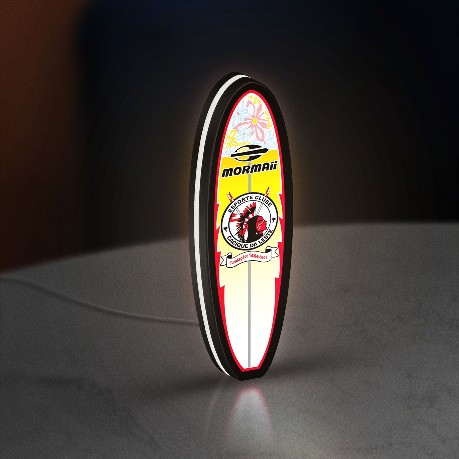 Mormai Surf LED lightbox standing on a desk from an angled side view with white glow