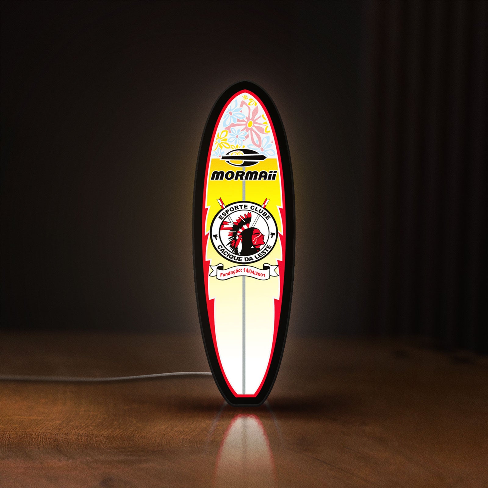 Front view of Mormai Surf LED lightbox sign glowing on a wooden desk