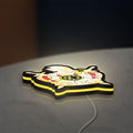 Ordem Demolay LED lightbox lying flat on a desk with yellow glow