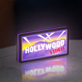 Hollywood Video LED lightbox standing on a desk from an angled side view with purple glow