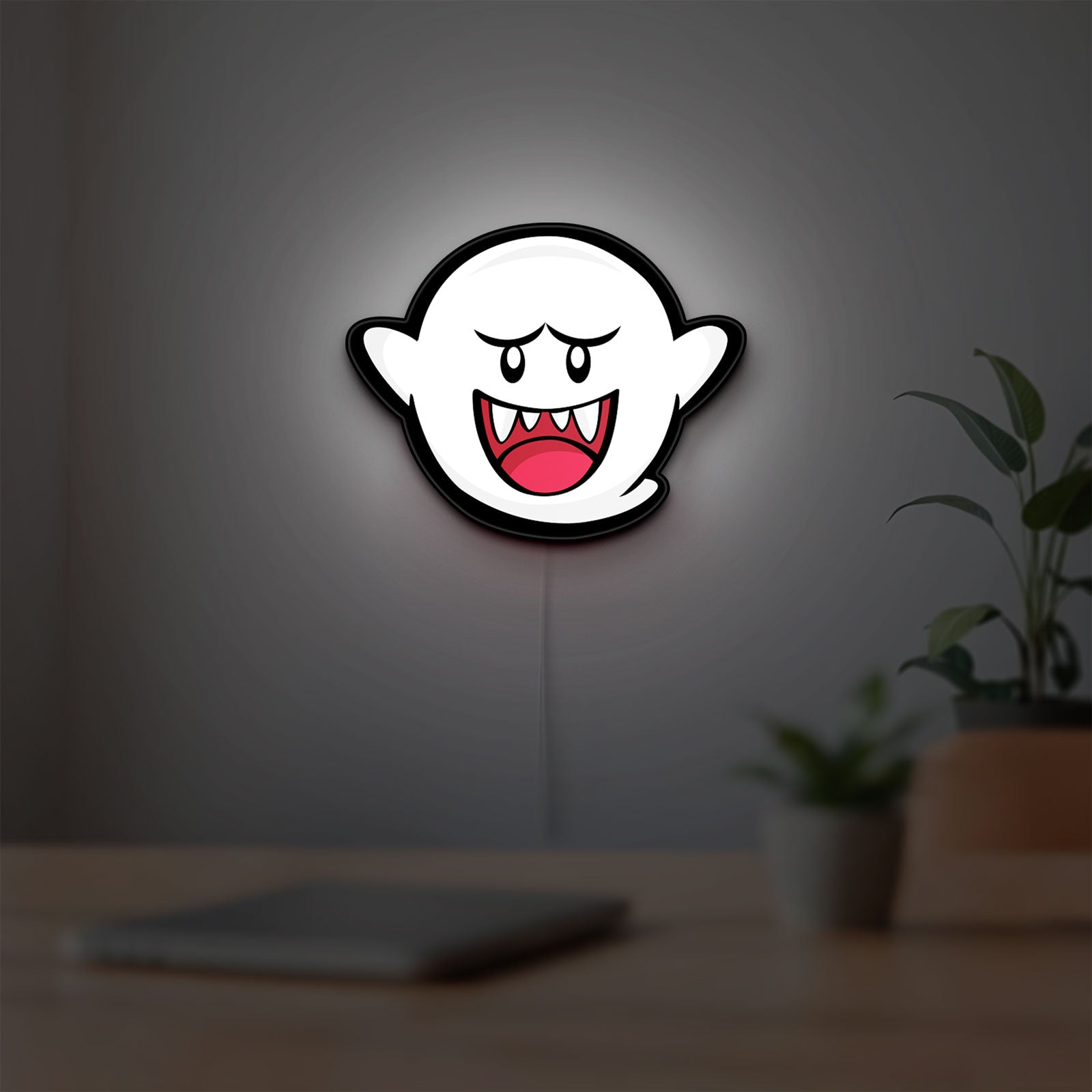 Boo LED lightbox hanging on a room wall with soft white light