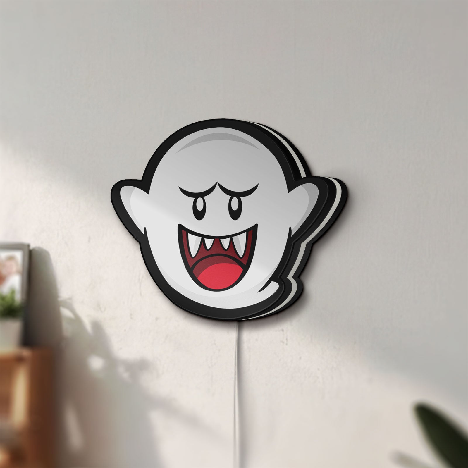 Unlit Boo LED lightbox mounted on a wall in daylight