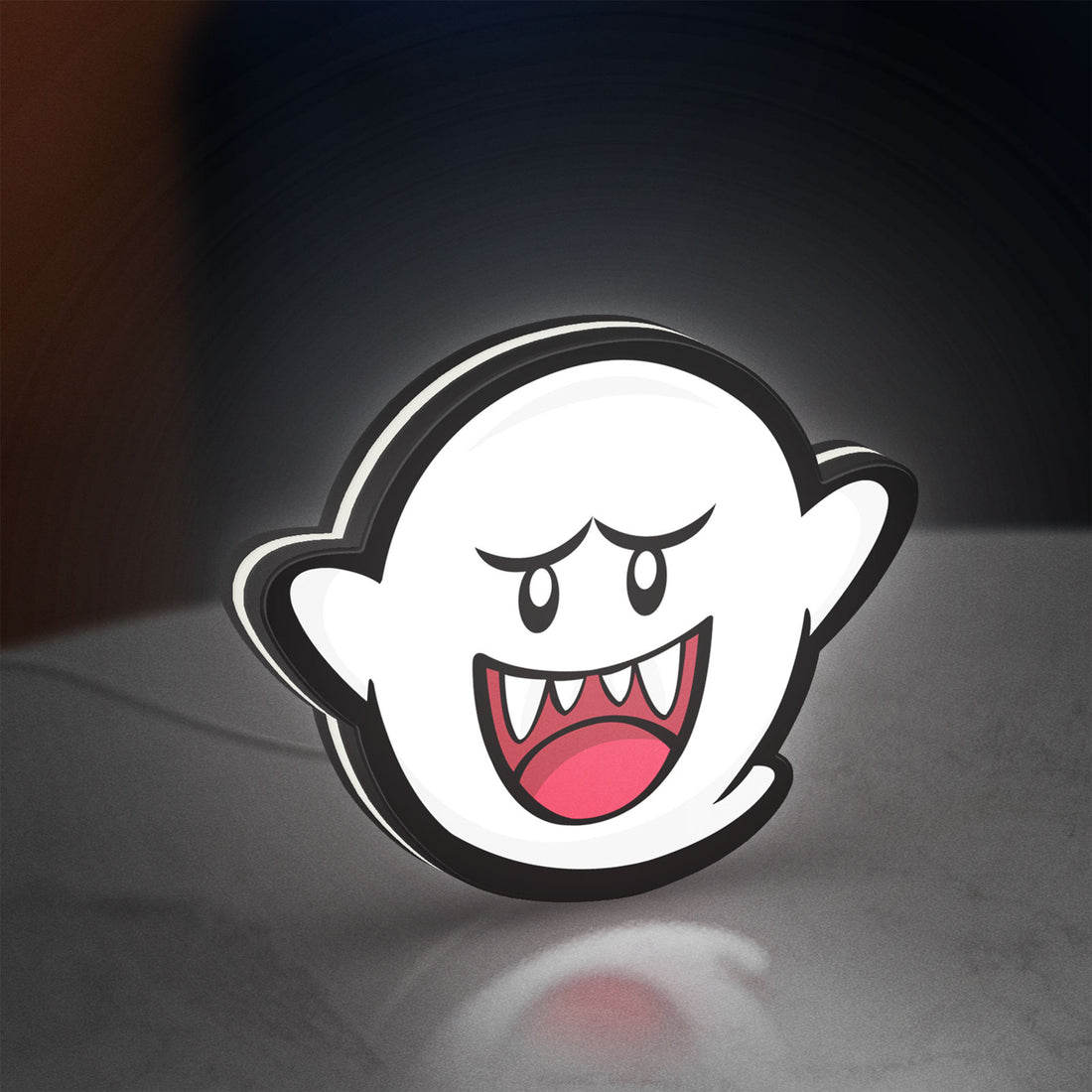 Boo LED lightbox hanging on a wall with white glow