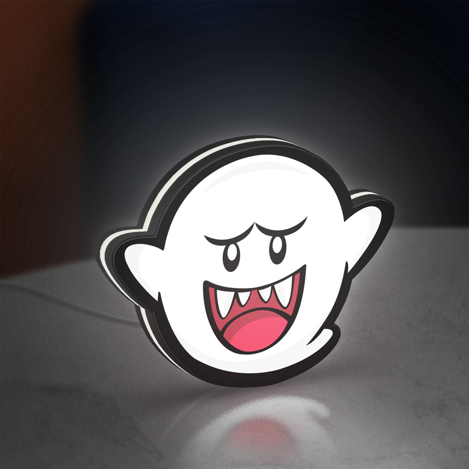 Boo LED lightbox standing on a desk from an angled side view with white glow