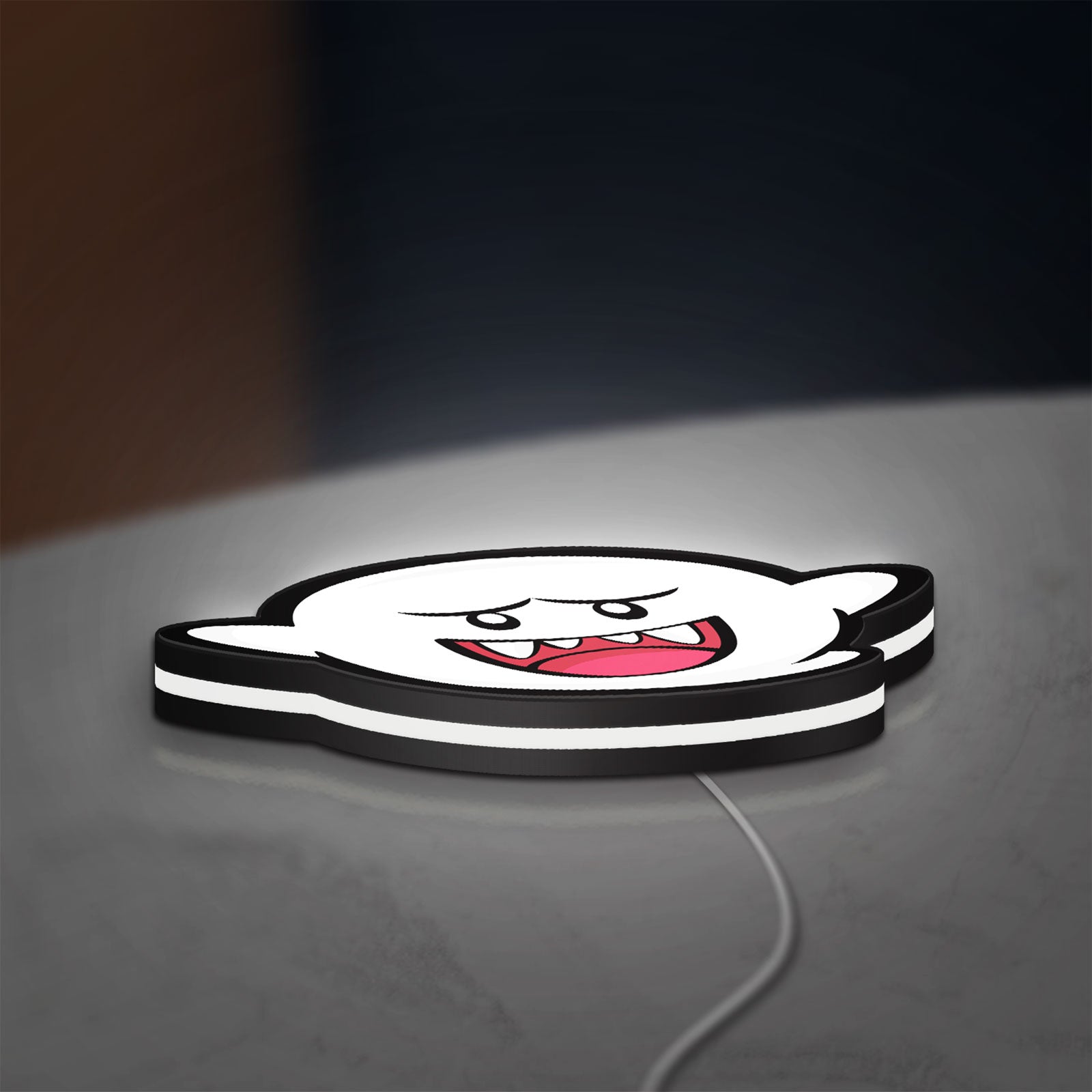 Boo LED lightbox lying flat on a desk with white glow