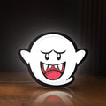 Front view of Boo LED lightbox sign glowing on a wooden desk