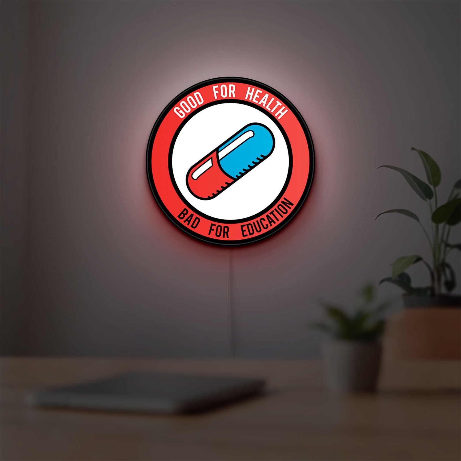 Akira Patch LED lightbox hanging on a room wall with soft red light
