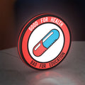 Akira Patch LED lightbox standing on a desk from an angled side view with red glow