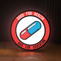 Front view of Akira Patch LED lightbox sign glowing on a wooden desk