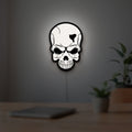 Skull LED lightbox hanging on a room wall with soft white light