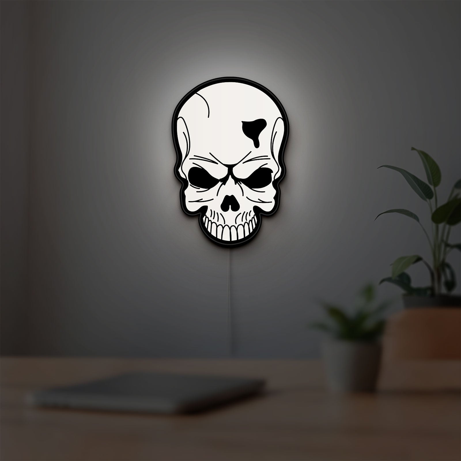 Skull LED lightbox hanging on a room wall with soft white light