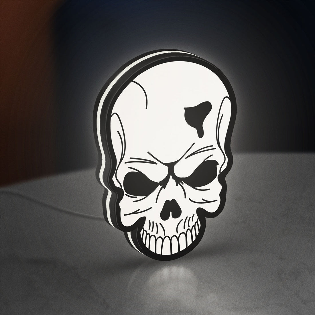 Skull LED lightbox hanging on a wall with white glow